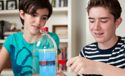 Two students work on a science project.