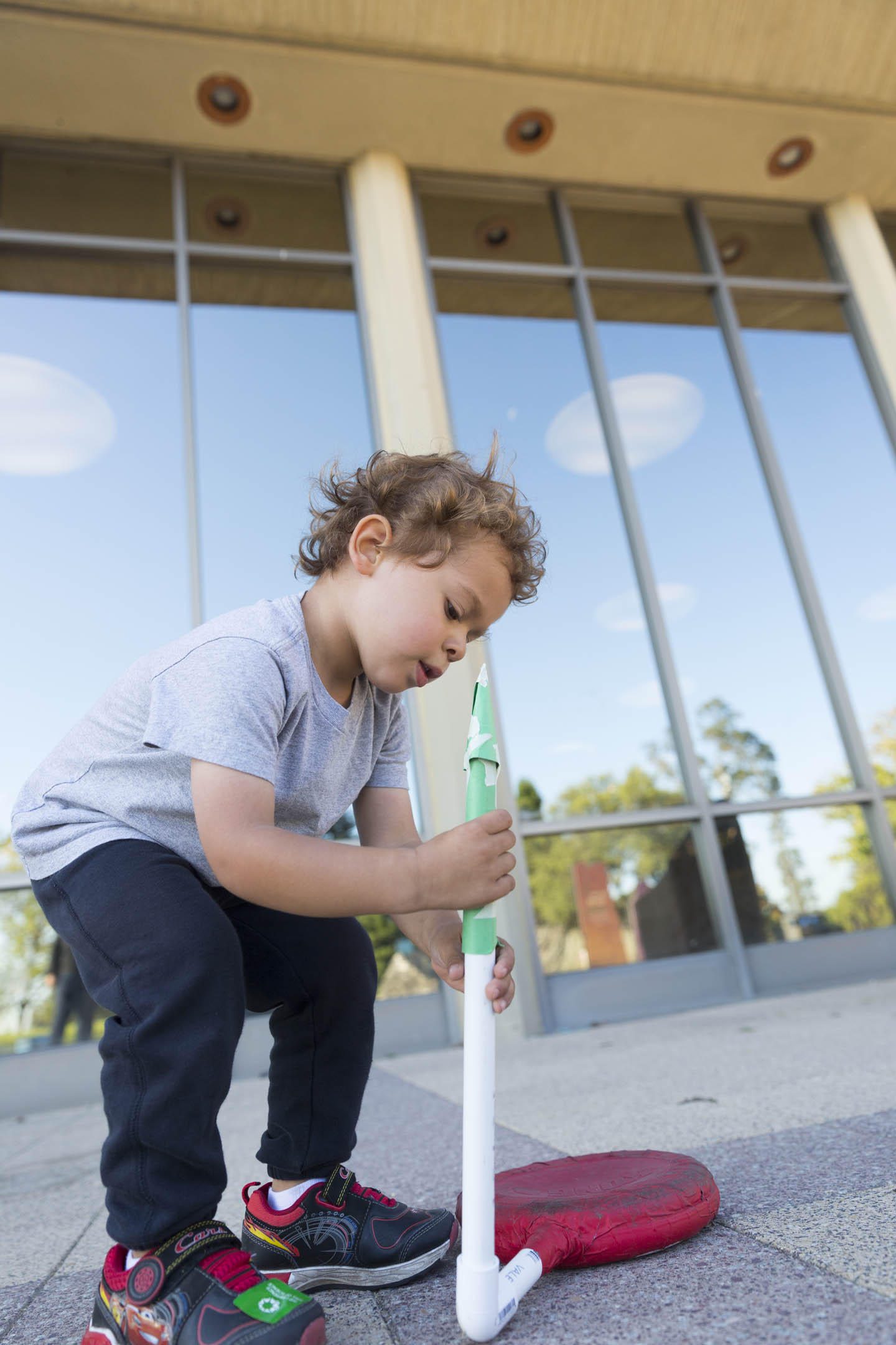 A child launching a handmade rocket during a science project